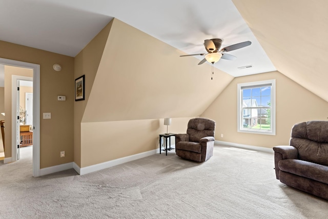 sitting room with carpet flooring, vaulted ceiling, ceiling fan, and baseboards