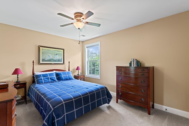 carpeted bedroom featuring baseboards and a ceiling fan