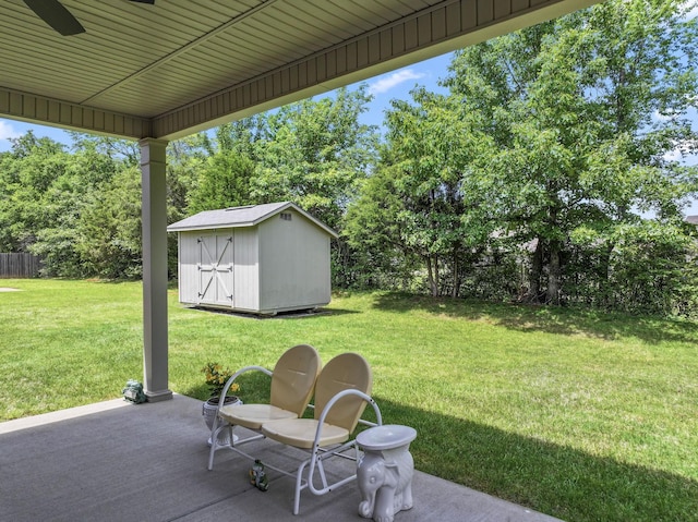 view of patio / terrace with a storage unit, an outbuilding, and view of scattered trees