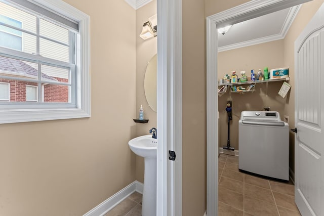 bathroom with washer / clothes dryer, ornamental molding, baseboards, and tile patterned flooring