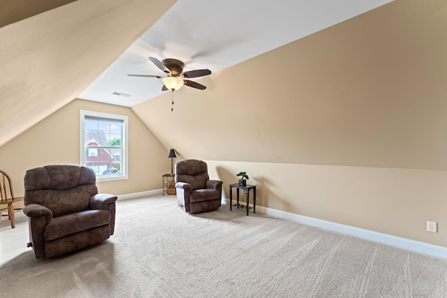living area with carpet floors, baseboards, lofted ceiling, and ceiling fan