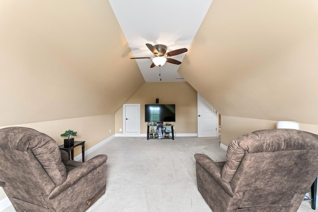 living area featuring a ceiling fan, light carpet, baseboards, and vaulted ceiling