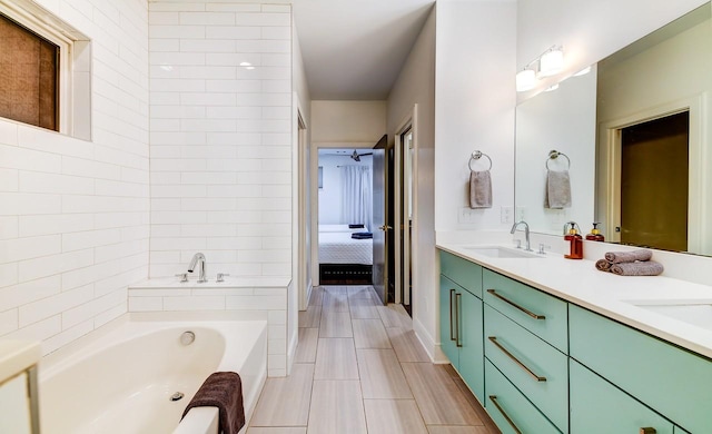 bathroom featuring a bath, double vanity, and ensuite bath