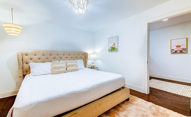 bedroom with dark wood-style floors and baseboards