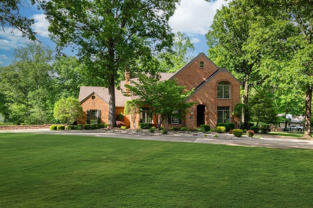 101 Oak Dr, Waverly, TN 37185 - view of front of house featuring a front lawn, brick siding, and a chimney