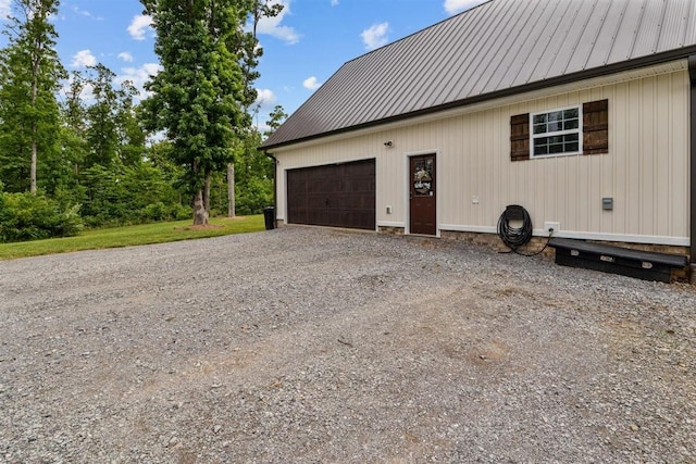 3571 Old Blacktop Rd, Mc Ewen, TN 37101 - view of side of property featuring a garage, metal roof, and driveway