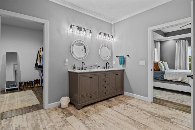 3571 Old Blacktop Rd, Mc Ewen, TN 37101 - bathroom with ensuite bathroom, double vanity, crown molding, baseboards, and wood finished floors