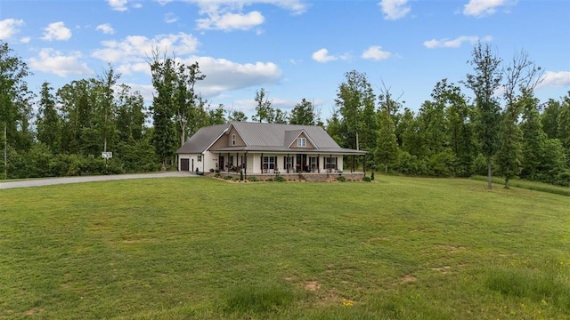 3571 Old Blacktop Rd, Mc Ewen, TN 37101 - view of front facade with a porch, asphalt driveway, an attached garage, and a front lawn
