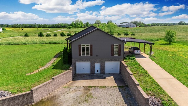 82 Staggs Rd, Ethridge, TN 38456 - view of home's exterior featuring gravel driveway, a lawn, a garage, and a view of rural / pastoral area