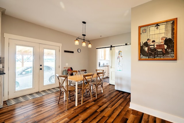 82 Staggs Rd, Ethridge, TN 38456 - dining space featuring french doors, a barn door, dark wood-style floors, and baseboards