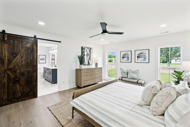 358 Coopertown Rd, Unionville, TN 37180 - bedroom featuring a barn door, connected bathroom, recessed lighting, light wood finished floors, and a ceiling fan