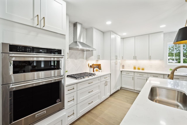 358 Coopertown Rd, Unionville, TN 37180 - kitchen featuring stainless steel appliances, wall chimney range hood, a sink, light countertops, and recessed lighting