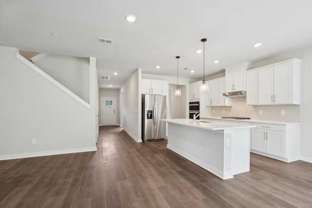 4621 Winslet Dr, Smyrna, TN 37167 - kitchen with stainless steel refrigerator with ice dispenser, a sink, gas cooktop, under cabinet range hood, and an island with sink