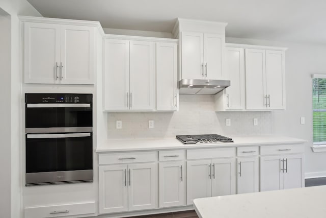 4621 Winslet Dr, Smyrna, TN 37167 - kitchen featuring under cabinet range hood, light countertops, white cabinetry, and tasteful backsplash