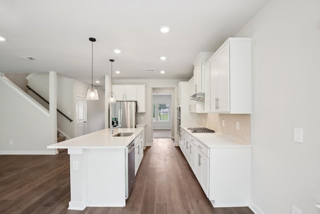 4621 Winslet Dr, Smyrna, TN 37167 - kitchen with stainless steel appliances, a sink, light countertops, a kitchen island with sink, and baseboards