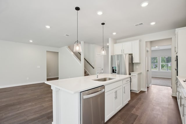 4621 Winslet Dr, Smyrna, TN 37167 - kitchen featuring appliances with stainless steel finishes, a sink, baseboards, dark wood-style floors, and a center island with sink