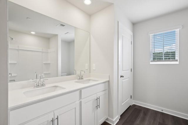 4621 Winslet Dr, Smyrna, TN 37167 - full bathroom with baseboards, wood finished floors, toilet, double vanity, and recessed lighting