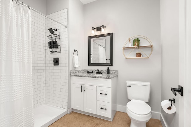 bathroom featuring a tile shower, toilet, baseboards, and vanity