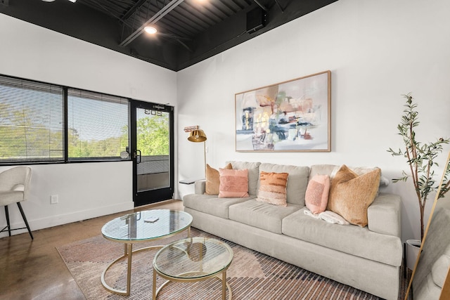 living area featuring concrete floors and baseboards