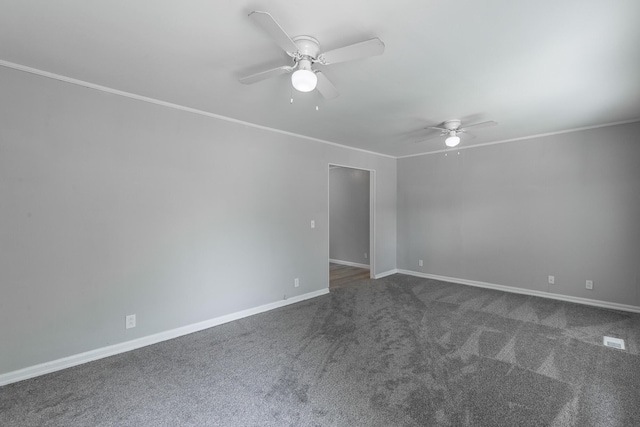 unfurnished room featuring ceiling fan, dark carpet, crown molding, and baseboards