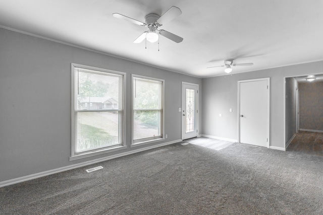 spare room with carpet flooring, ceiling fan, ornamental molding, and baseboards