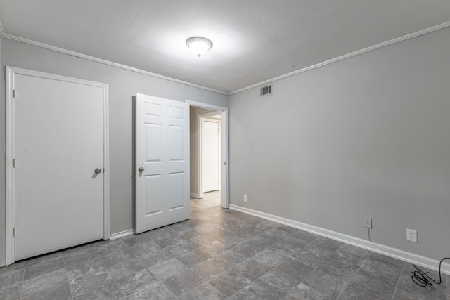 unfurnished bedroom with crown molding and baseboards
