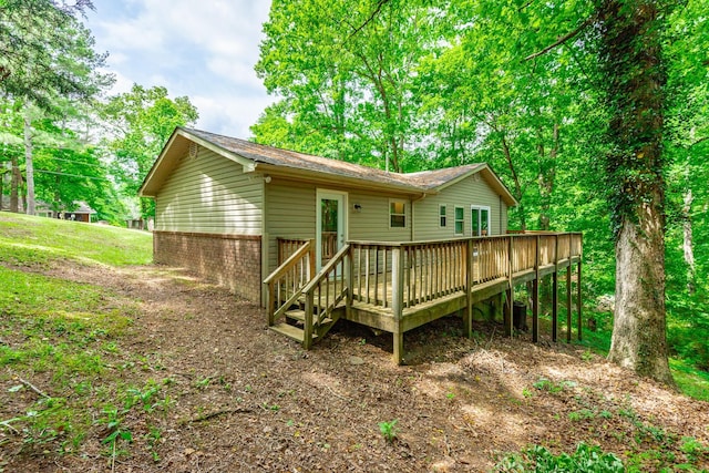 back of house with a wooden deck and brick siding