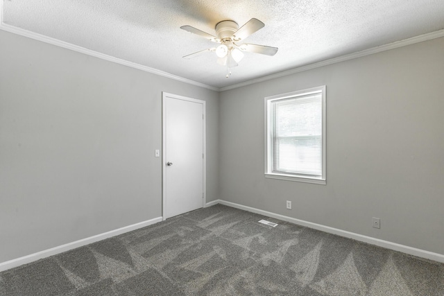 spare room with dark carpet, a ceiling fan, ornamental molding, a textured ceiling, and baseboards