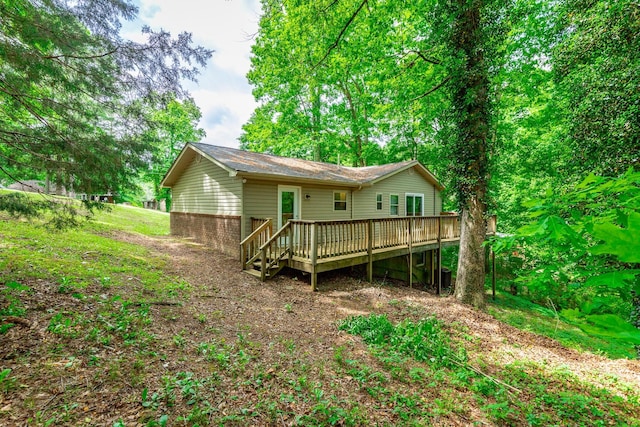 rear view of house featuring a wooden deck