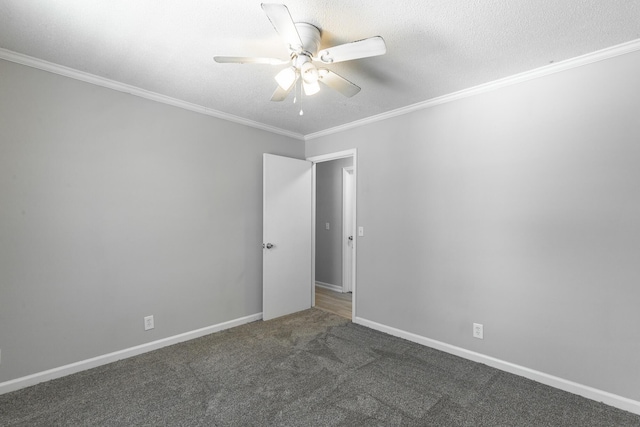 carpeted spare room featuring ceiling fan, crown molding, baseboards, and a textured ceiling