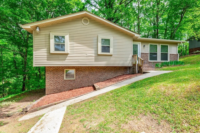 ranch-style house with a front yard, brick siding, and entry steps