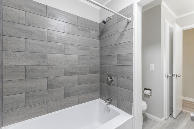 full bathroom with ornamental molding, toilet, wood finished floors,  shower combination, and baseboards