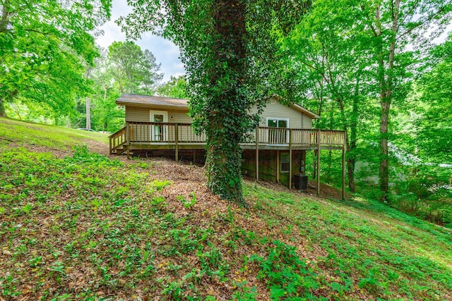 back of house featuring a deck and central AC unit