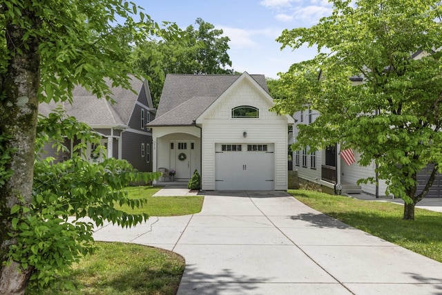 513 Westboro Dr, Nashville, TN 37209 - view of front of home with a garage, concrete driveway, roof with shingles, and a front lawn
