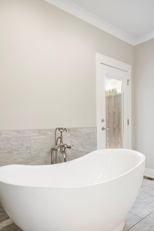 513 Westboro Dr, Nashville, TN 37209 - full bath with ornamental molding, a freestanding bath, and tile walls