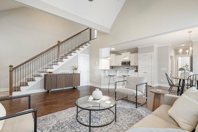 513 Westboro Dr, Nashville, TN 37209 - living area with stairway, dark wood-type flooring, baseboards, a towering ceiling, and crown molding