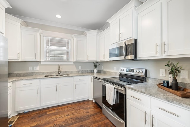 513 Westboro Dr, Nashville, TN 37209 - kitchen with stainless steel appliances, a sink, white cabinets, recessed lighting, and dark wood-style floors