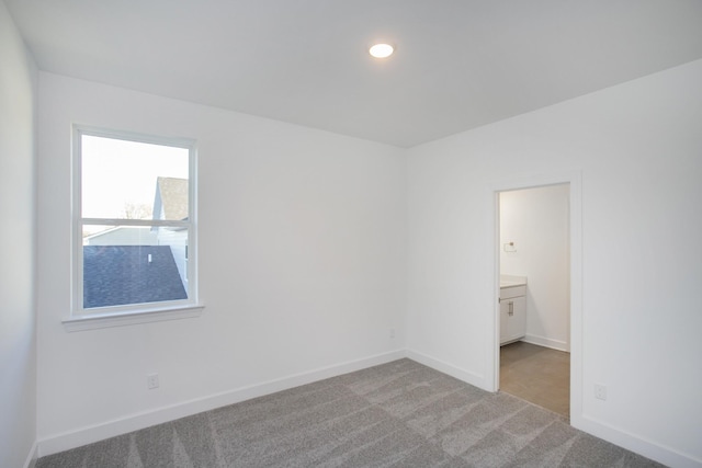 empty room with light colored carpet, baseboards, and recessed lighting