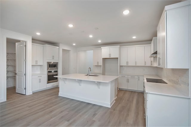 113 W Cassa Way, Mount Juliet, TN 37122 - kitchen with appliances with stainless steel finishes, a sink, light wood finished floors, decorative backsplash, and recessed lighting