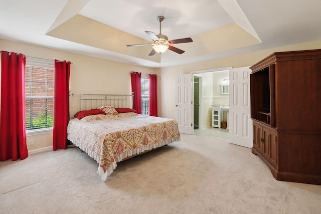 2130 River Chase Dr, Murfreesboro, TN 37128 - bedroom featuring a tray ceiling, light carpet, multiple windows, and a ceiling fan
