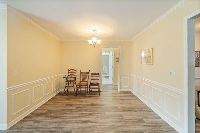 2130 River Chase Dr, Murfreesboro, TN 37128 - dining area with a decorative wall, a chandelier, crown molding, wood finished floors, and wainscoting