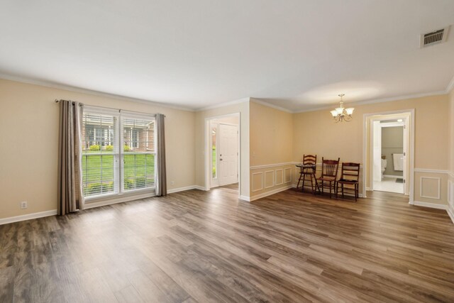 2130 River Chase Dr, Murfreesboro, TN 37128 - living area with a chandelier, wood finished floors, crown molding, a decorative wall, and a wainscoted wall