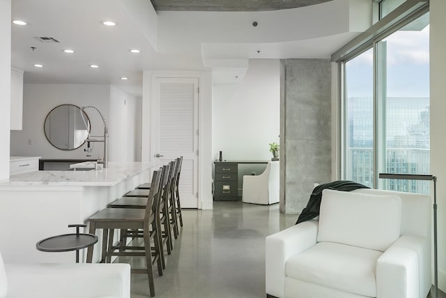 dining area with finished concrete flooring and recessed lighting