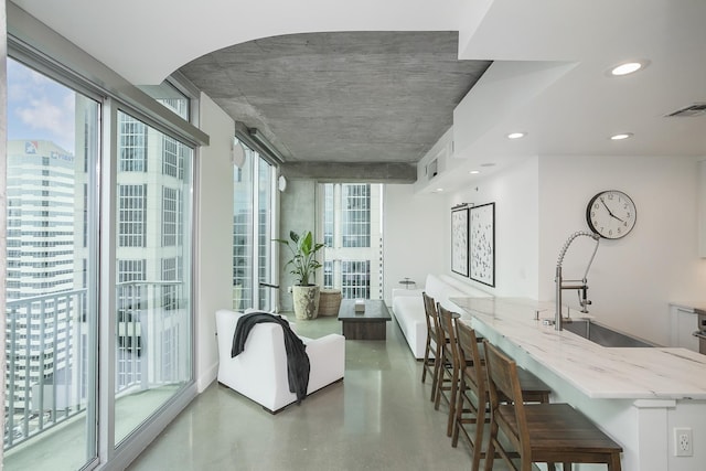dining area with concrete flooring and recessed lighting