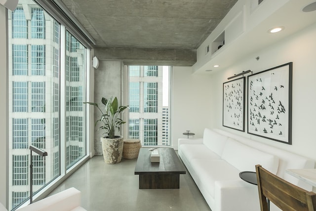 interior space with finished concrete floors, recessed lighting, and a barn door
