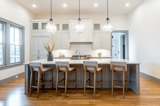 504 Doubleday Ln, Brentwood, TN 37027 - kitchen featuring a kitchen island with sink, tasteful backsplash, light countertops, a sink, and recessed lighting