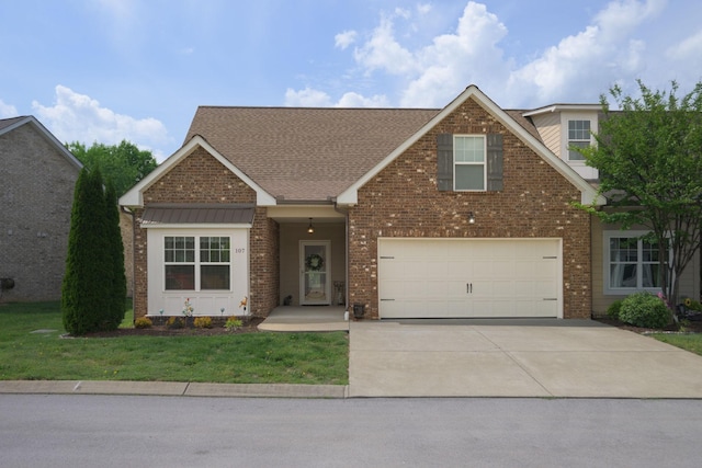view of front facade with concrete driveway, roof with shingles, an attached garage, a front yard, and brick siding