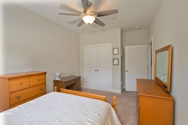 carpeted bedroom with a closet, ceiling fan, and baseboards