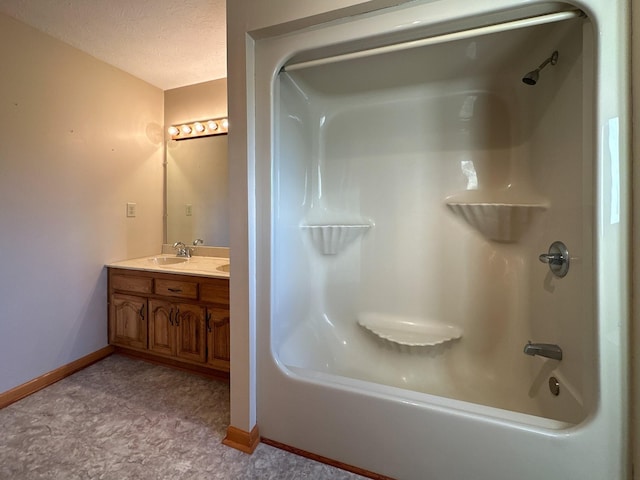 311 Locust St, Alexandria, TN 37012 - bathroom with baseboards, washtub / shower combination, double vanity, and a textured ceiling