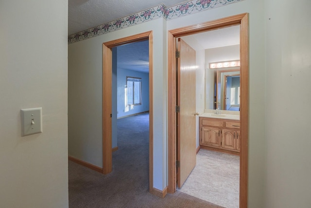 311 Locust St, Alexandria, TN 37012 - hallway featuring light carpet, a sink, and baseboards